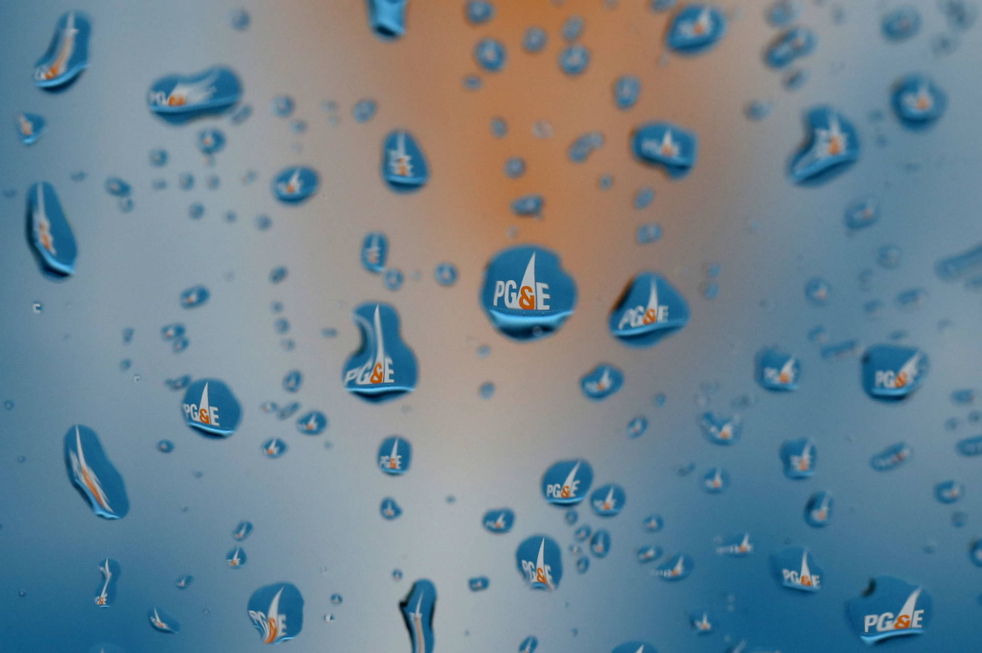 PG&amp;E logo visible through raindrops on a San Francisco window in January 2019. The company faces new criminal probation conditions growing out of its role in the deadly wildfires of 2017 and 2018.  Justin Sullivan/Getty Images