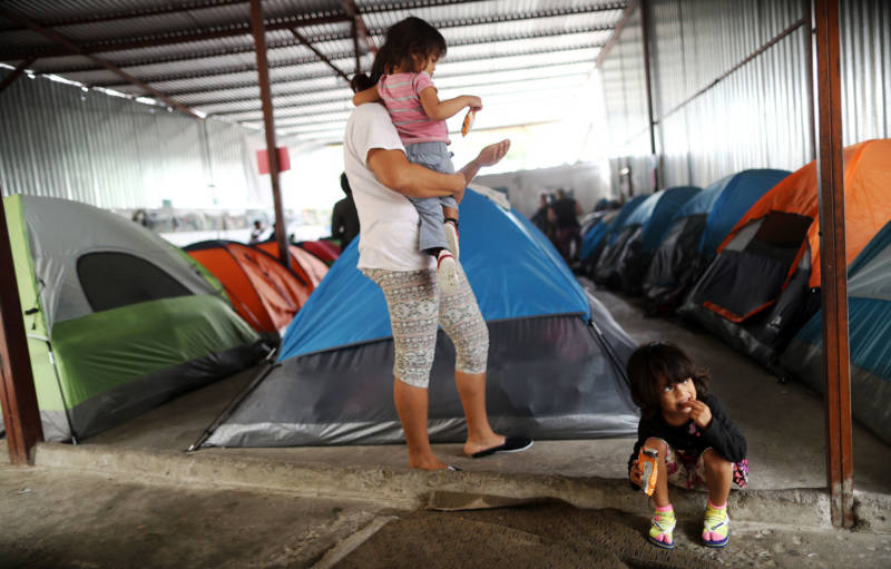 A Honduran mother stands with her daughters in the migrant shelter where they are currently living near the U.S.-Mexico border on April 4, 2019 in Tijuana. She said they are on the waiting list to apply for asylum in the U.S. and must wait at the shelter for now.