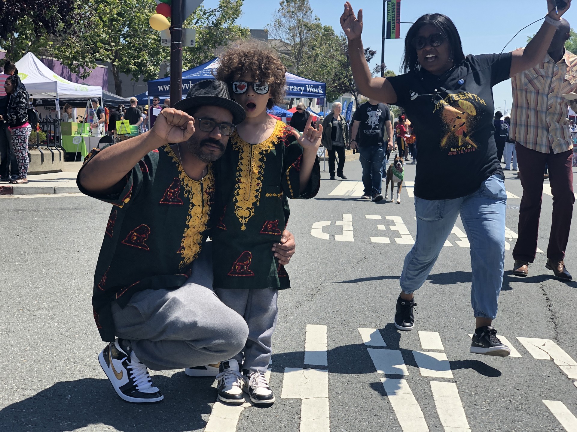Dakh Jones and his son Enrico (and a Juneteenth photobomber) celebrate black pride in South Berkeley, where Jones was born and raised. 'It's significant that this celebration has not completely phased out, that it's still important for the Berkeley city,' he said.