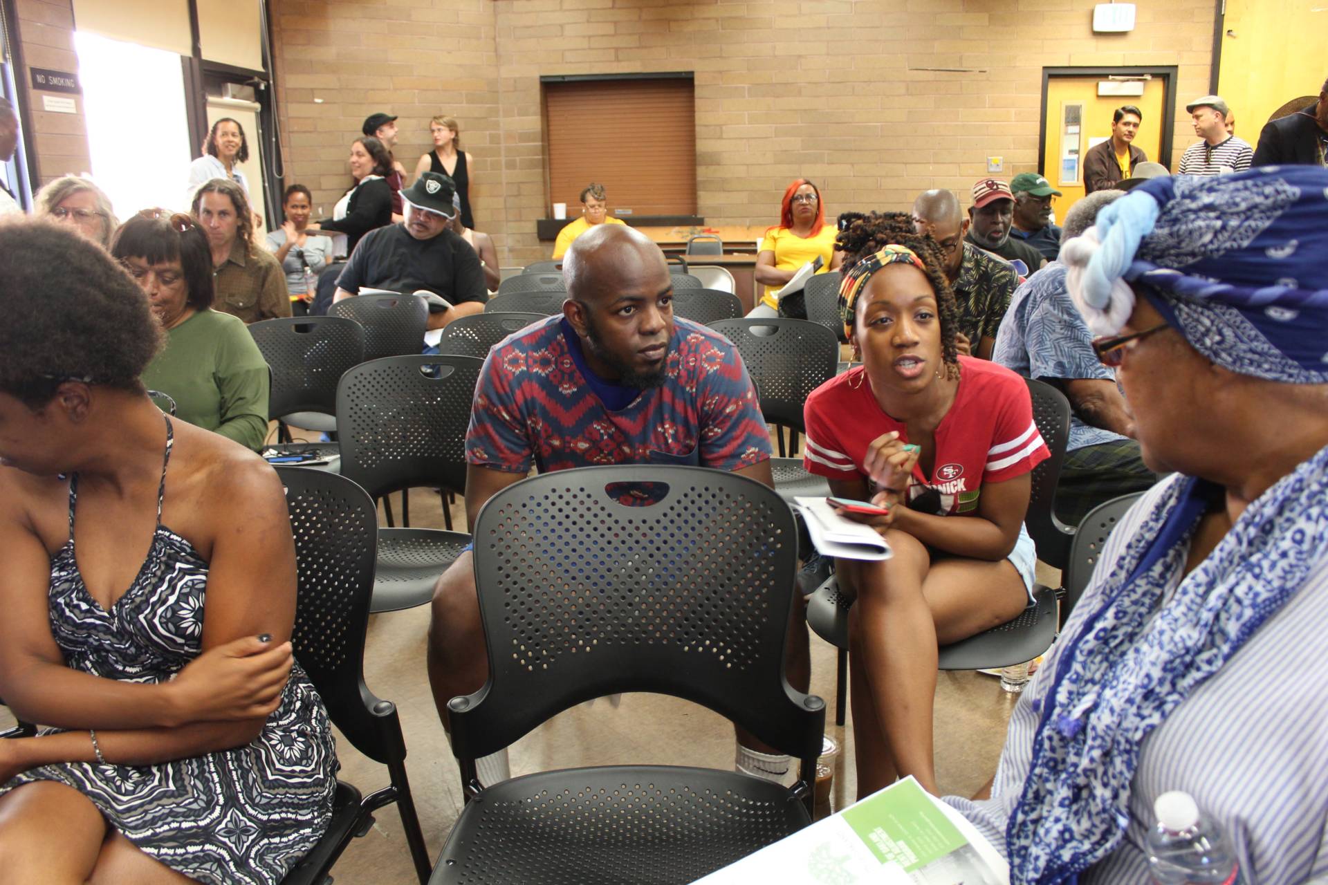 From L-R, Anthony Smith, Solaire Spellen and April Haley talk during a break at the second African-American Tenants Union gathering, the first was held in May. Oakland resident Haley said she learned about the event from friends.