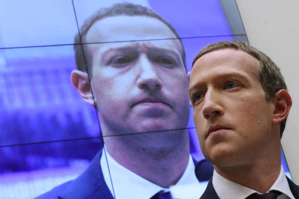 WASHINGTON, DC - OCTOBER 23: With an image of himself on a screen in the background, Facebook co-founder and CEO Mark Zuckerberg testifies before the House Financial Services Committee in the Rayburn House Office Building on Capitol Hill October 23, 2019 in Washington, DC. Zuckerberg testified about Facebook's proposed cryptocurrency Libra, how his company will handle false and misleading information by political leaders during the 2020 campaign and how it handles its users’ data and privacy.