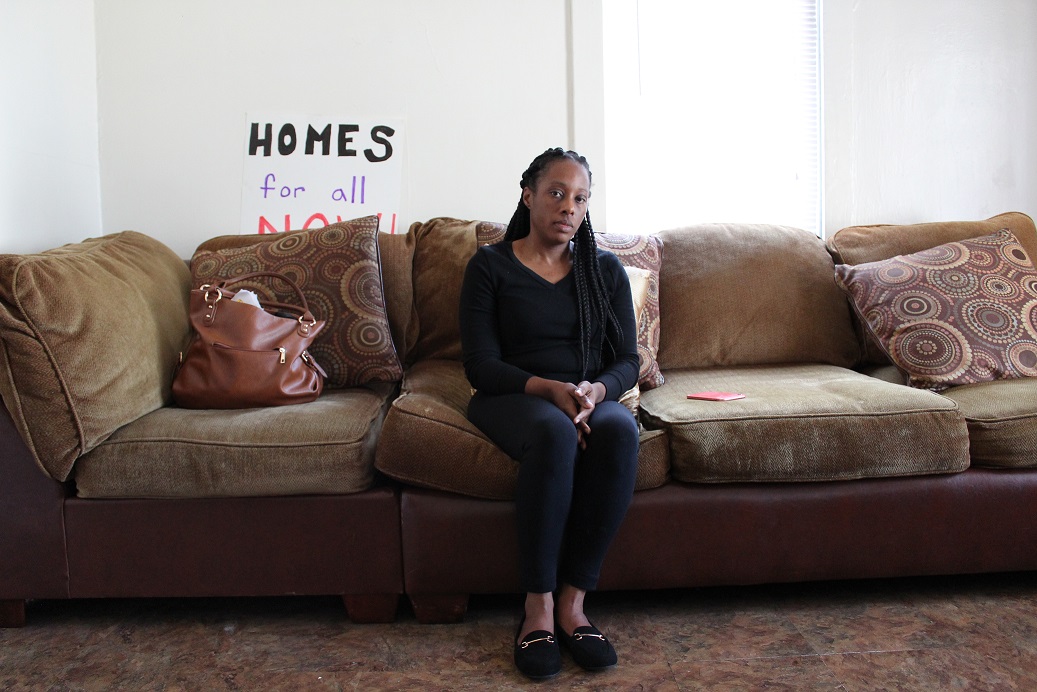 Dominique Walker, a member of the group Moms 4 Housing, sits in a West Oakland home that's been vacant for two years. Walker and other homeless mothers have been occupying the home since November.