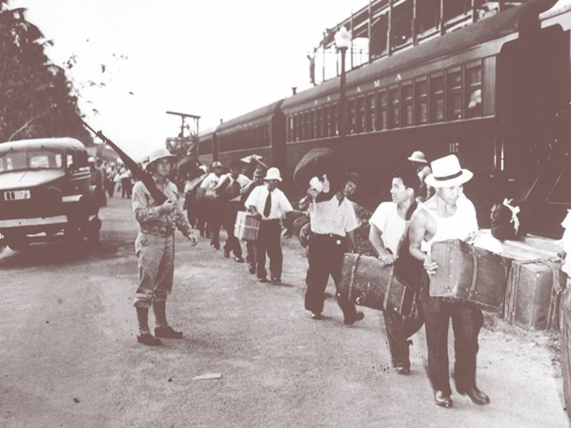 Japanese Peruvian men in the Panama Canal Zone heading to detention in the U.S., April 2, 1942. Koshio Henry Shima (2nd from right) was a named plaintiff in a 1996 lawsuit against the U.S. government seeking redress.