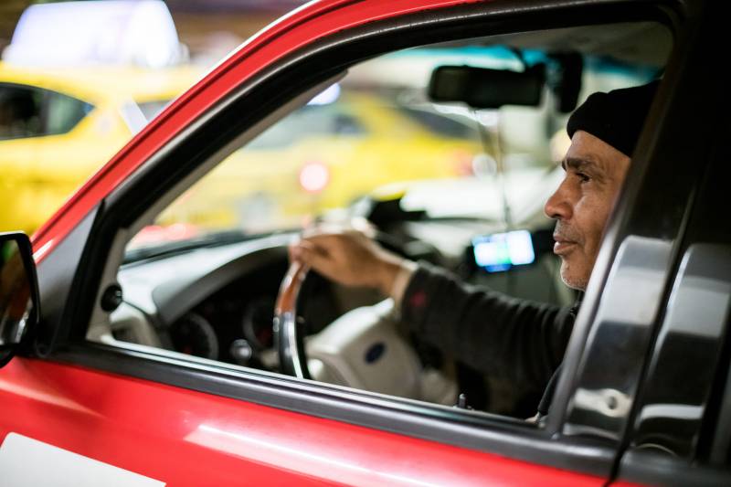 Ejaz Ahmed waits in the short term parking garage at San Francisco International Airport on Jan. 30, 2020. Taxi drivers can often wait up to an hour or more waiting to pick up a fare.