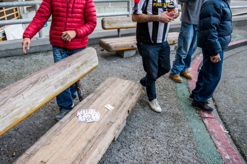 Taxi drivers play cards while they wait to pick up passengers at San Francisco International Airport on Jan. 30, 2020.