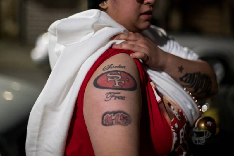 Gloria Rodarte shows her 49ers tattoo on Alabama Street after the game on Sunday. She said the loss wasn't going to stop her from celebrating her team.