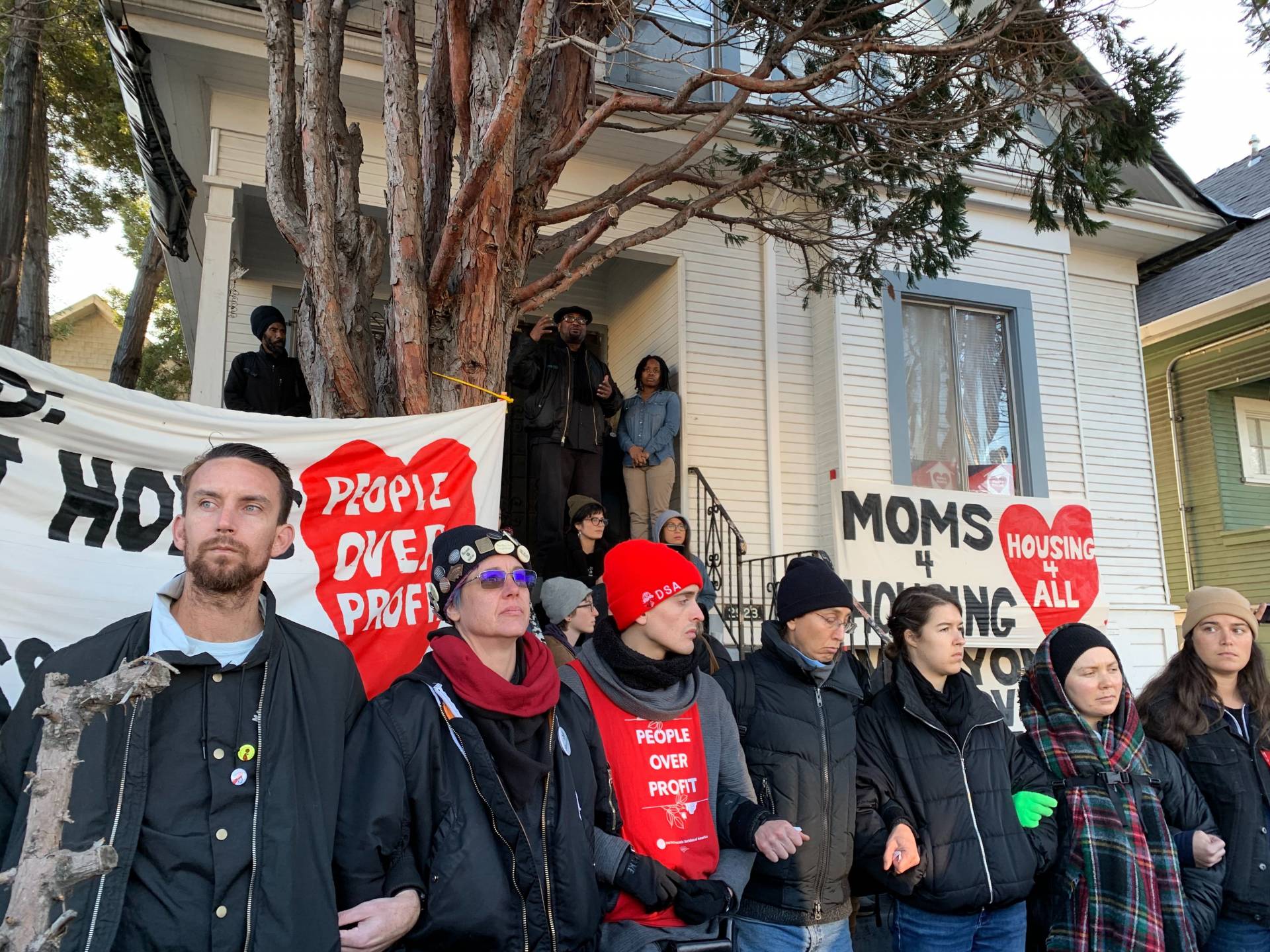 Supporters of Moms 4 Housing rally in front of the West Oakland house the group occupied for several months before being forcefully evicted in January. A community land trust has since agreed to purchase the house and allow the women move back in.