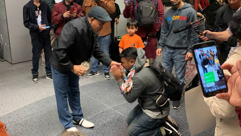 As a sign of respect and reverence in Cambodian culture, Sok Loeun kneeled at his father’s feet after arriving back in the U.S. for the first time in five years.