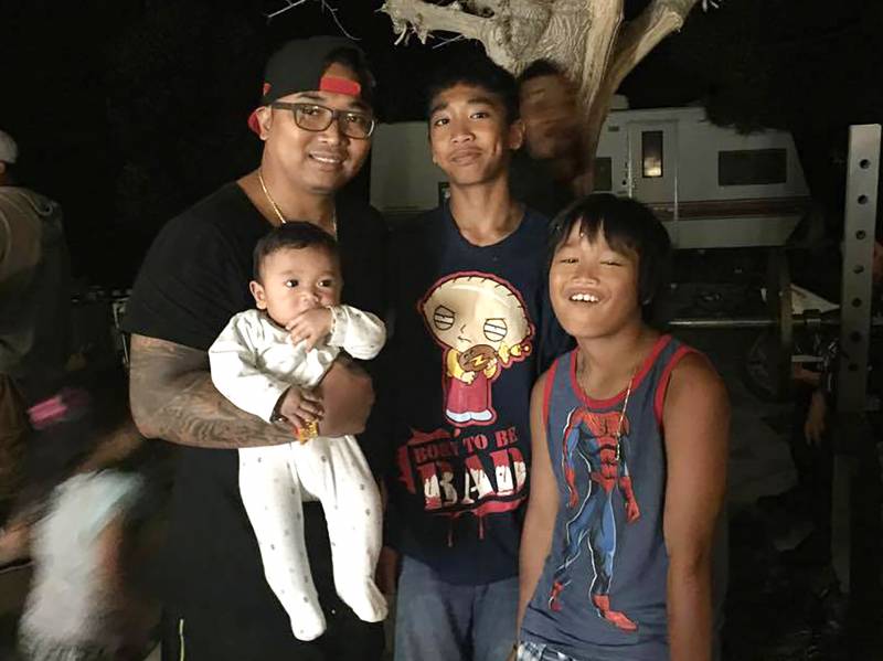 Sok Loeun (left) with his three sons during the last weekend before he boarded his flight to Cambodia five years ago.
