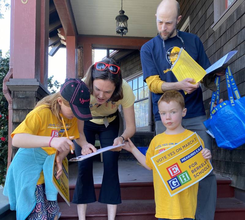 Dan and Jenny Mulholland-Beahrs with their kids, Callie and Joel, go door to door in support of Measure E on the March 3 ballot, which would raise local property taxes to fund raises for teachers in Berkeley Unified School District.