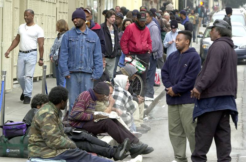 Dozens of homeless people line up for a meal at St. Anthony's Church on Dec. 6, 2002 in San Francisco.