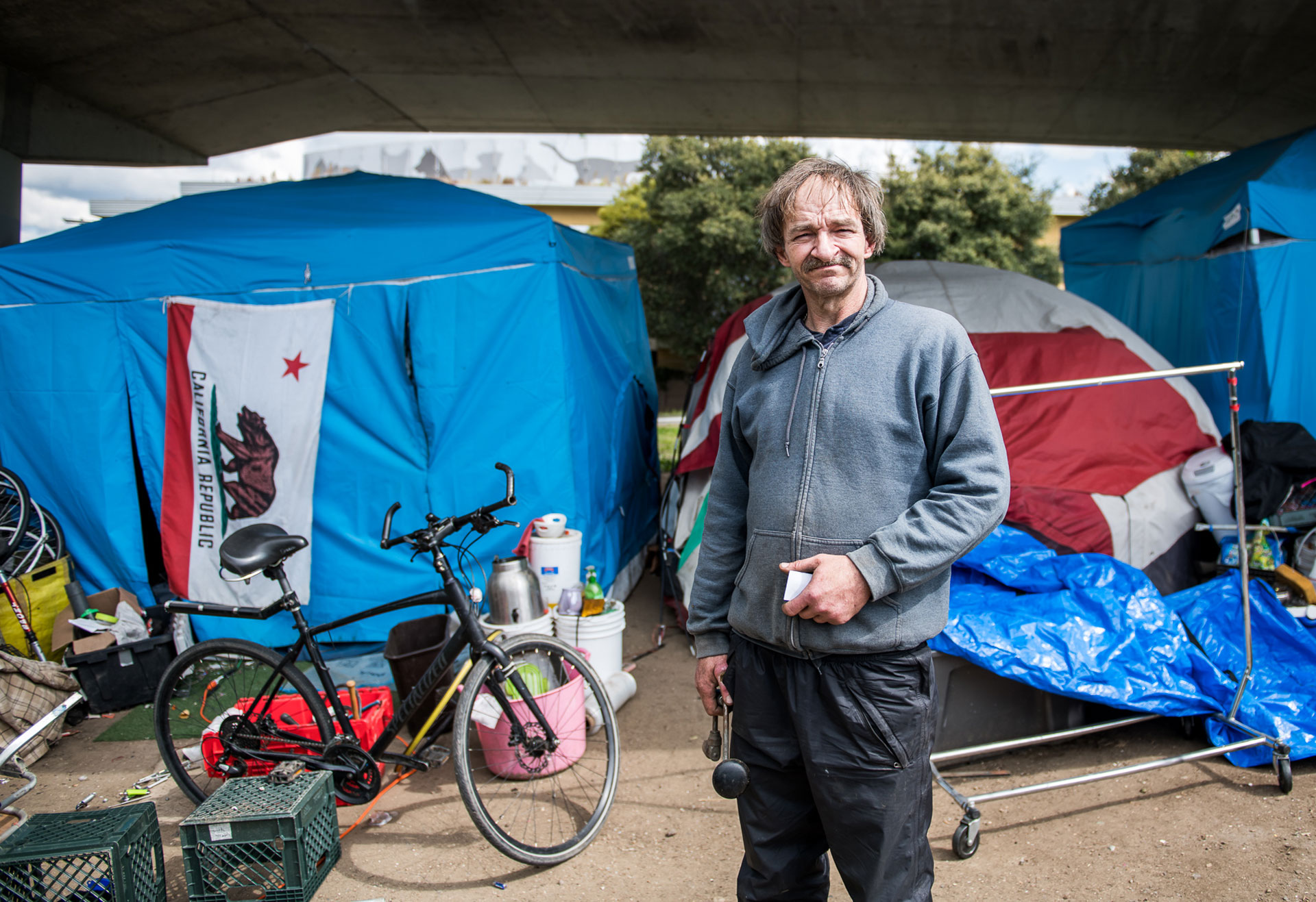 Kevin Coddington, 52, at the tent encampment where he lives under a freeway overpass in Berkeley on Mar. 19, 2020. When asked about outreach to his community in response to the coronavirus crisis, he said, "It's very scary. They haven't given us anything." He said that private donations were all that they had received, which helps them to supply their own portable restrooms, but that they could use running water as well as masks, gloves and sanitizer.