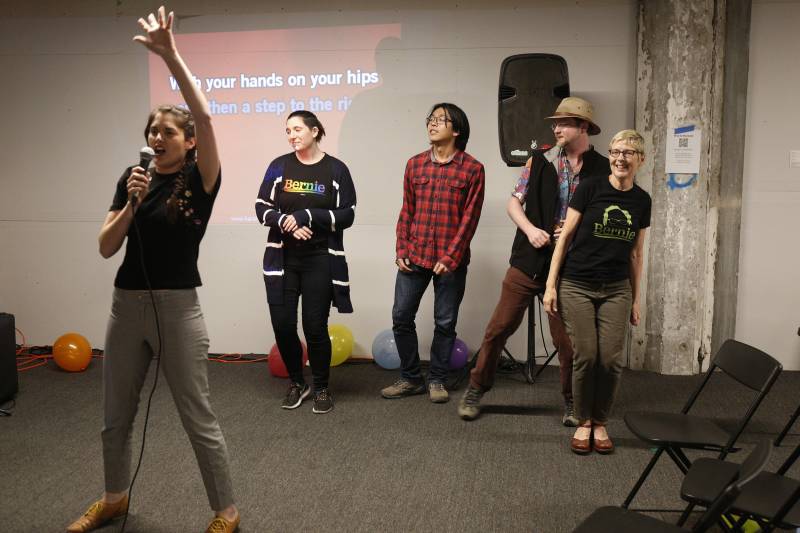 Bernie Sanders supporters sing karaoke at campaign headquarters after the Senator's victory in California on Tuesday, March 3, 2020 in Oakland, Ca.