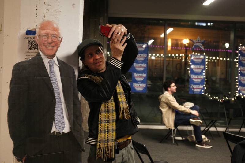 Patrick Jacobson takes a selfie with a cardboard cut out of Bernie Sanders after the Vermont Senator won the California Primary on Super Tuesday. Jacobson does community building at Bridge Art and Storage Space where lots of political art is created. He said he felt “smiles from within" after Sanders' victory.