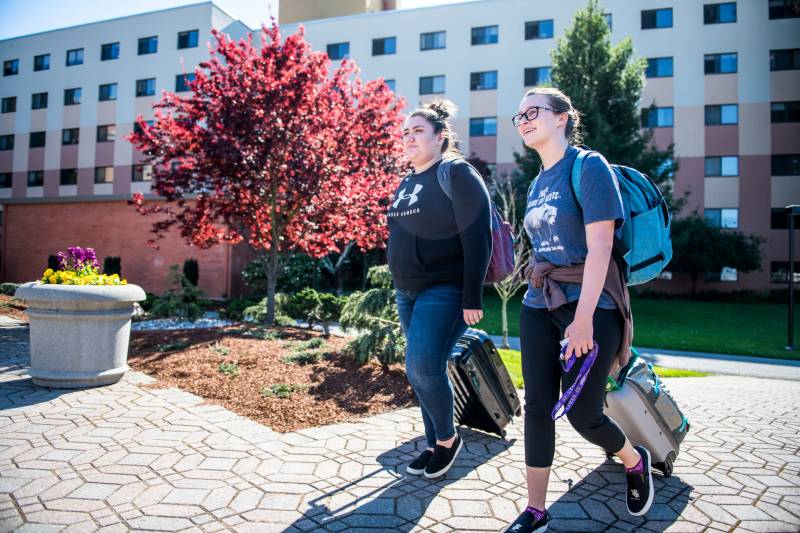 San Francisco State University freshman students Alexa Nunez (left) and Abbey Gassaway walk with their belongings to turn in their room keys on Wednesday, Mar. 11, 2020. The university advised students to move out of their dorms and return home to help curb the spread of coronavirus.