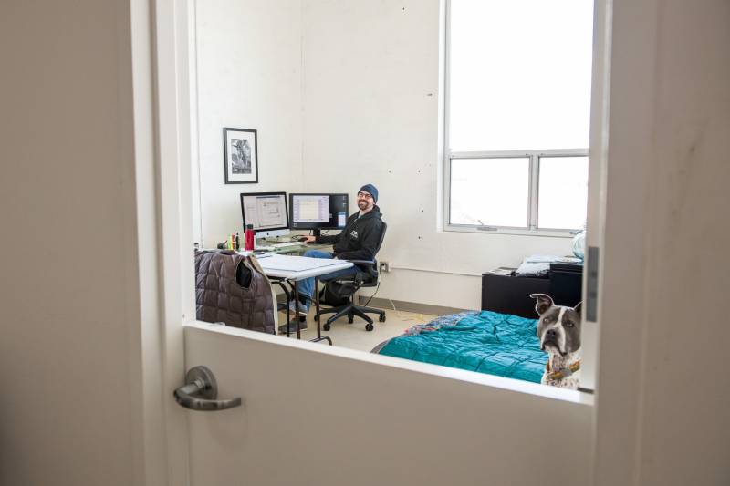 Katie Wojnoonski and her husband Andy (pictured) are sheltering in place in the offices of the Dog Social Club in Oakland.