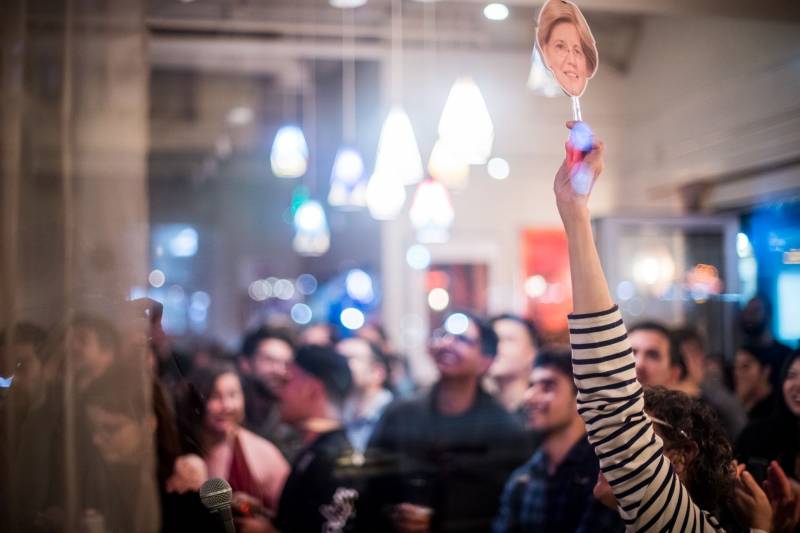 An Elizabeth Warren supporter watches results come in at a Democratic watch party at Manny’s in San Francisco on Tuesday, Mar. 3, 2020.