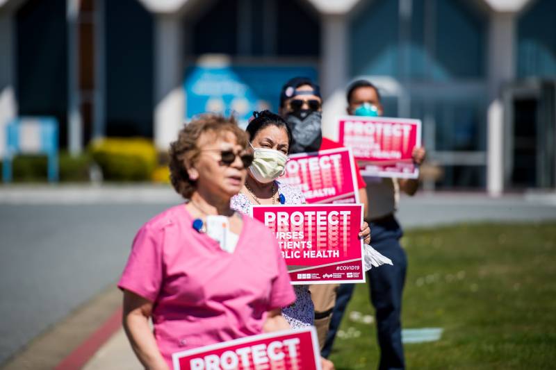 Medical workers and supporters rally to raise awareness of the lack of N95 masks and other medical supplies at Seton Medical Center at a demonstration organized by the California Nurses Union on April 2, 2020.