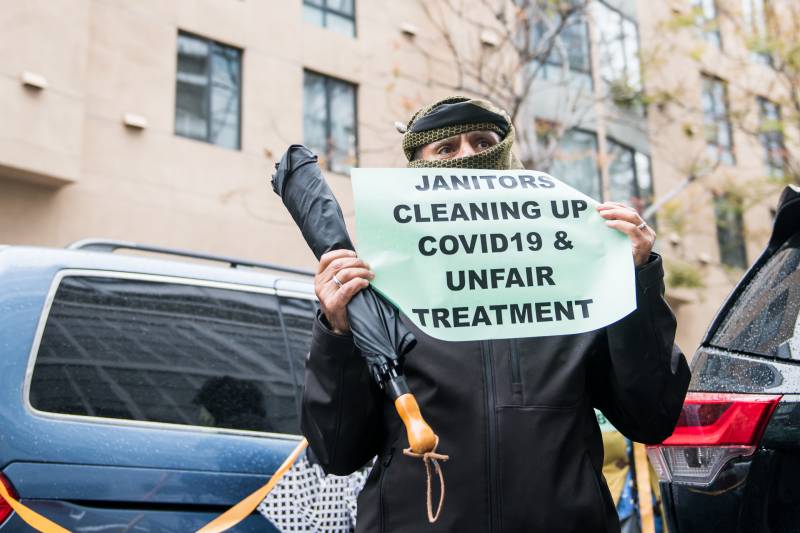 Madi Deonah, a janitor at 130 Kearny Street in San Francisco, protests alongside fellow janitors outside of Lyft headquarters on April 6, 2020.