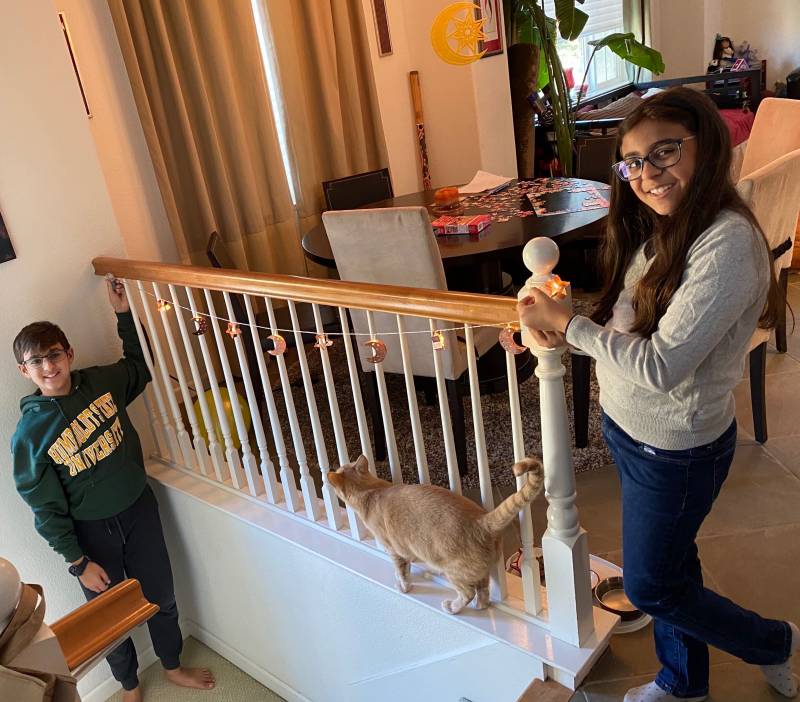 Sameena Usman's two children, Saleh Khan (13, left) and Serene (10, right) are decorating their house in preparation for Ramadan while sheltering in place this year.