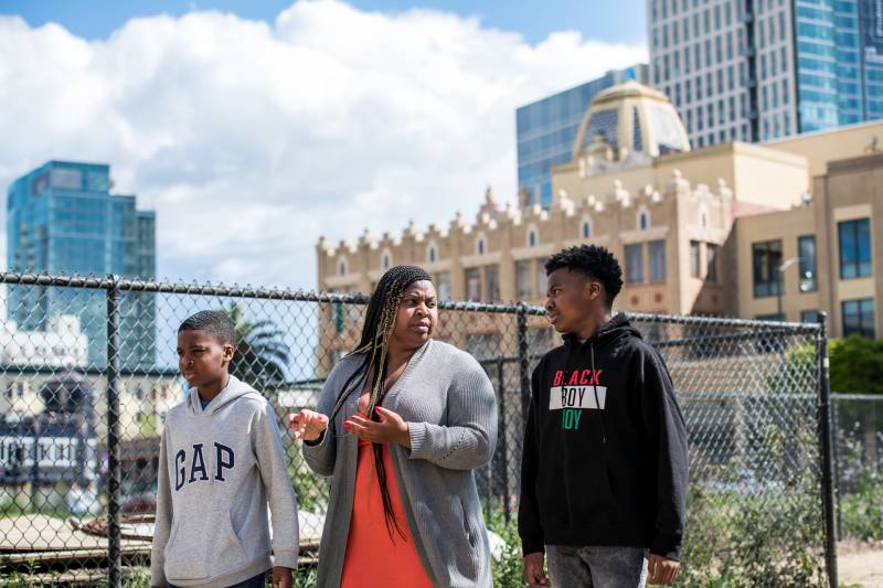 Carolyn Bims-Payne and her two sons take a daily walk around their neighborhood in Oakland on Mar. 26, 2020.