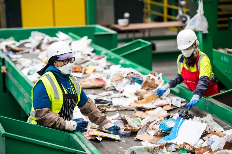 Recology employees separate garbage from recyclables at a processing facility at Pier 96 in San Francisco on April 9, 2020.