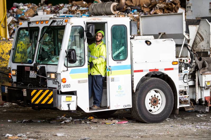 A truck full of recyclables unloads its contents onto the "tipping floor" at Recology's processing facility in San Francisco on April 9, 2020.