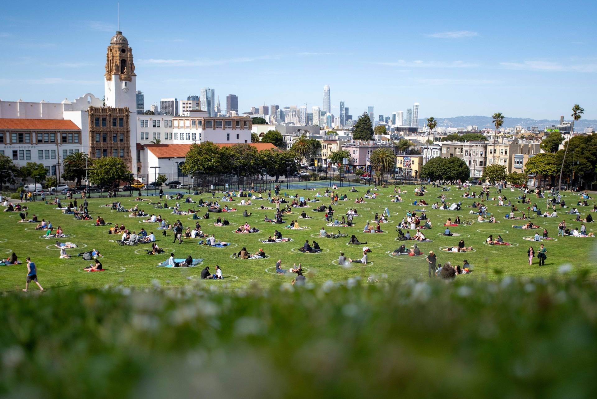People gather inside painted circles on the grass meant to encourage social distancing at Dolores Park in San Francisco on May 22, 2020. Josh Edelson/AFP via Getty Images