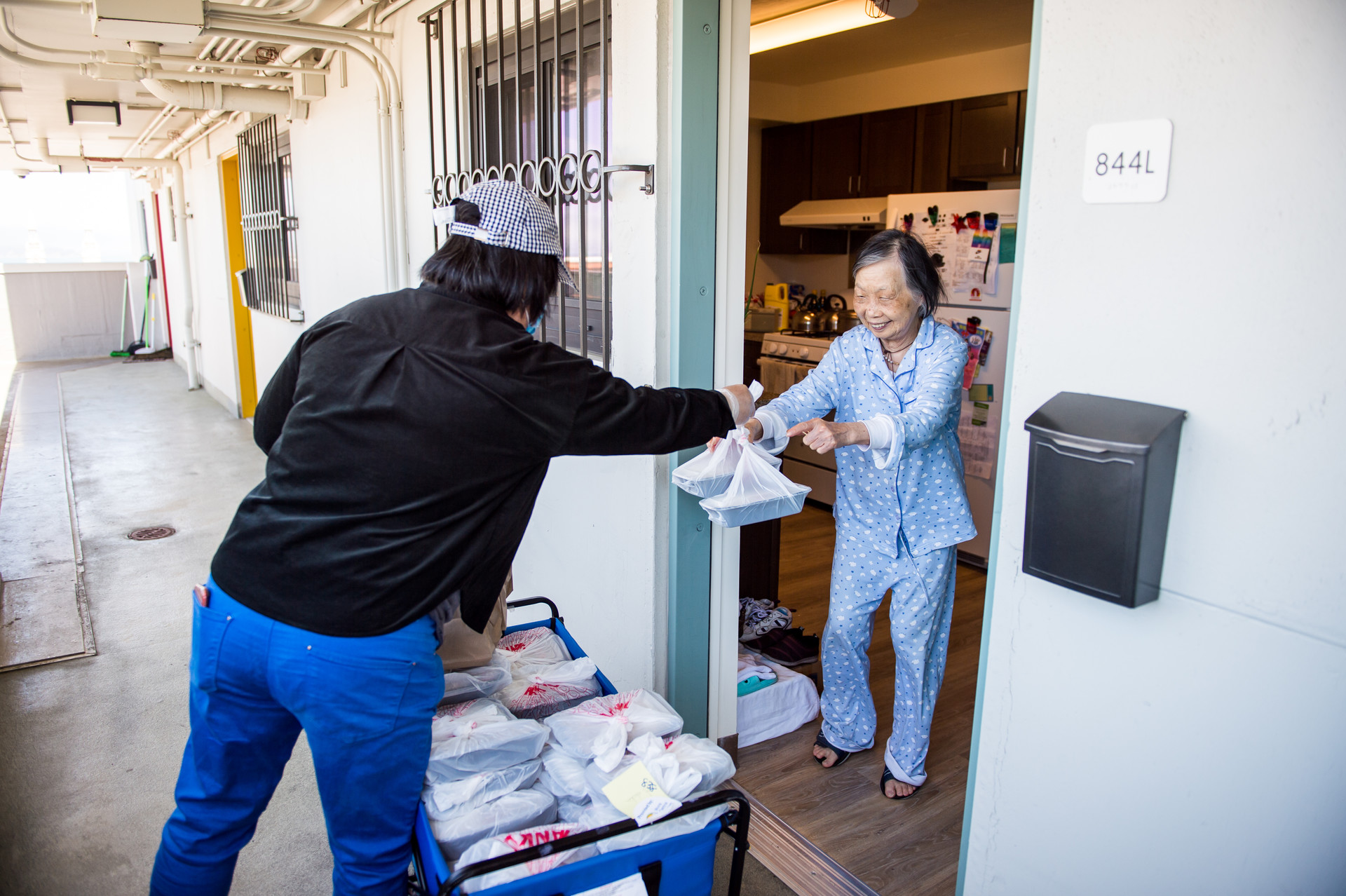 Ruqiong Fang delivers meals to residents at Ping Yuen, a public housing building in Chinatown, on April 5, 2020. Fang volunteers five days a week to help deliver meals.