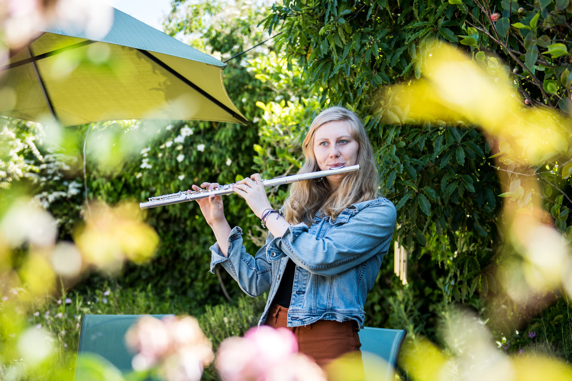 Genevieve Schweitzer, a junior in high school, plays the flute in her backyard on April 6, 2020.