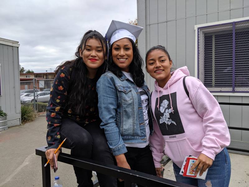 Rudsdale college and career counselor, Natalie Lizardo-Sarellano poses in a graduation hat with two recent graduates, Sulma Vasquez and Diana de Paz Chepio. 