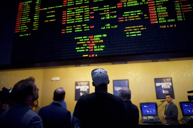 Sports bettors place wagers at a casino on June 5, 2018 in Delaware, the first state to launch legal sports betting since a Supreme Court decision allowing it.