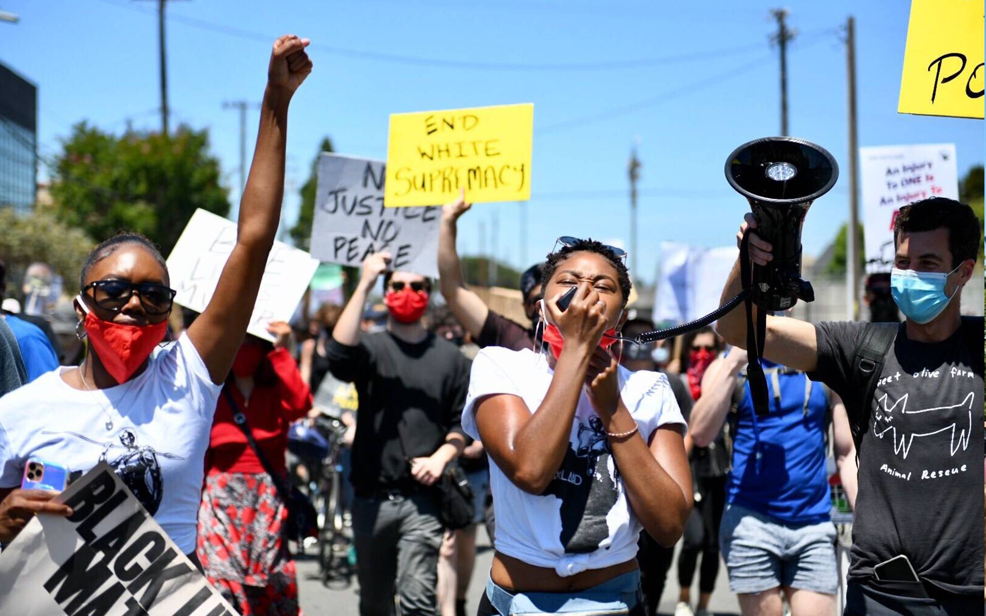 Adrianna Mitchell (center) and Akilah Walker march from the Port of Oakland to Downtown during a Juneteenth rally on June 19, 2020. Beth LaBerge/KQED