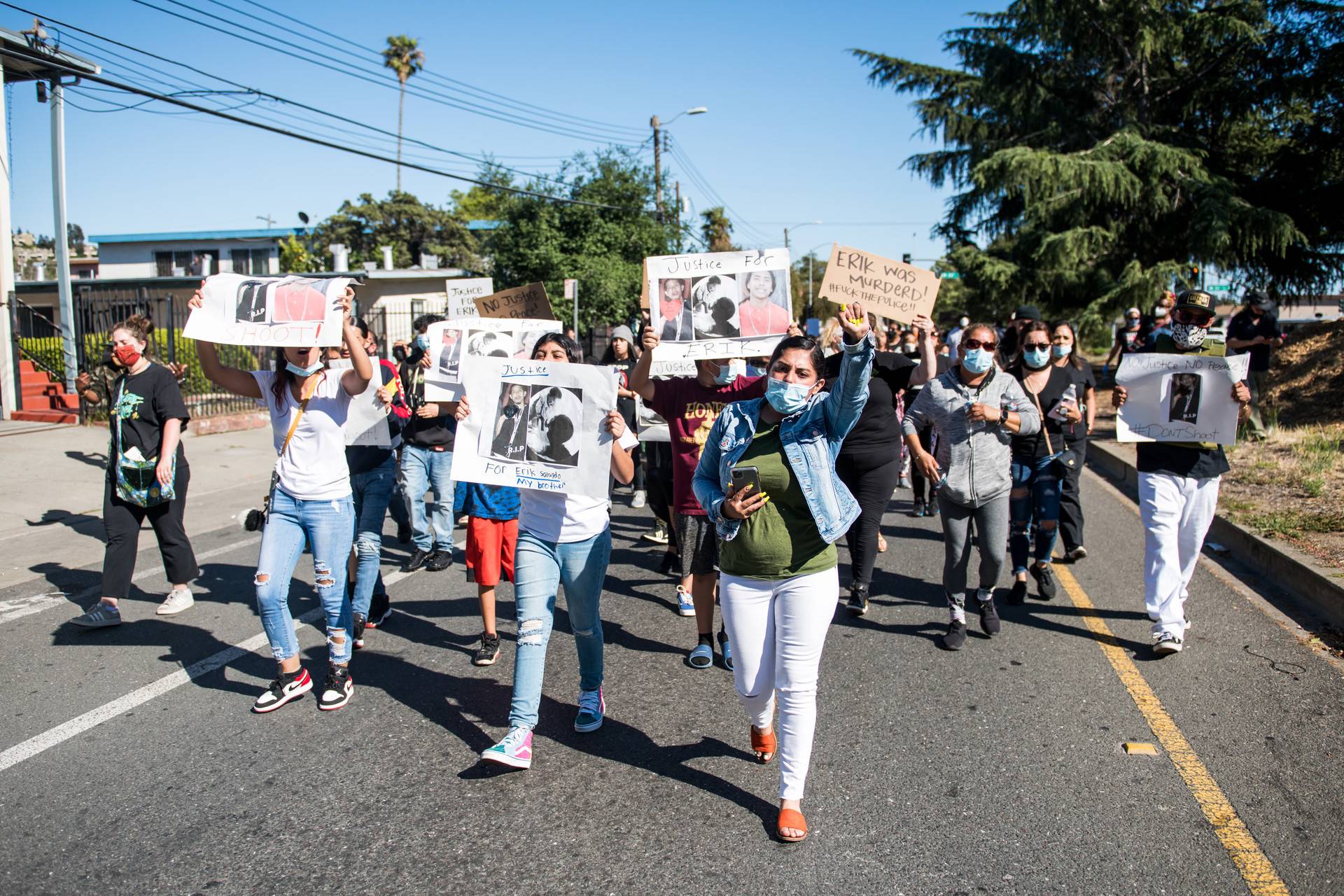 The family of Erik Salgado lead a large procession, marching from Elmhurst Middle School in East Oakland on Monday, June 8, to the site where Erik Salgado was shot and killed by California Highway Patrol officers this weekend. Beth LaBerge/KQED