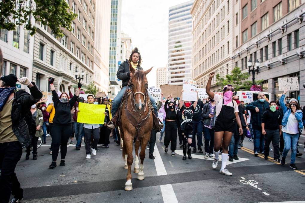 Brianna Noble rode her horse Dapple Dan down Broadway in Oakland on May 29, 2020, during a protest over the Minneapolis police killing of George Floyd.
