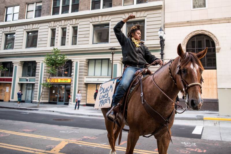 Brianna Noble and her horse Dapper Dan were among demonstrators marching on Broadway in Oakland on May 29, 2020, during a protest over the Minneapolis police killing of George Floyd.