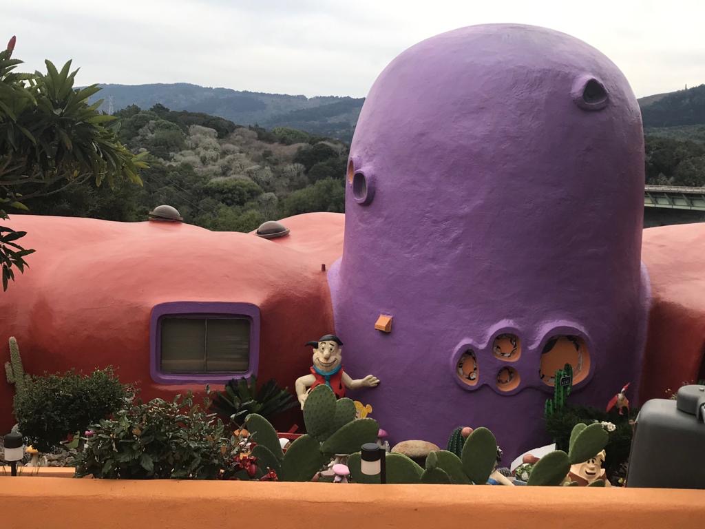 The current owner Florence Fang didn't come up with the nickname "Flintstone House," but she's run with it, installing all kinds of cartoonish tchotchkes inside and out. 