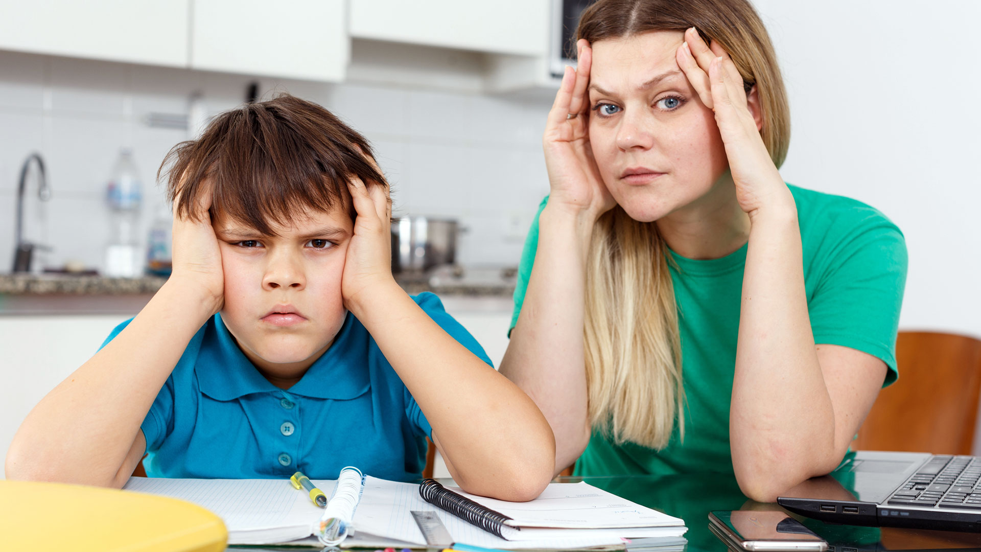 A mom and her son look fed up with learning at home.
