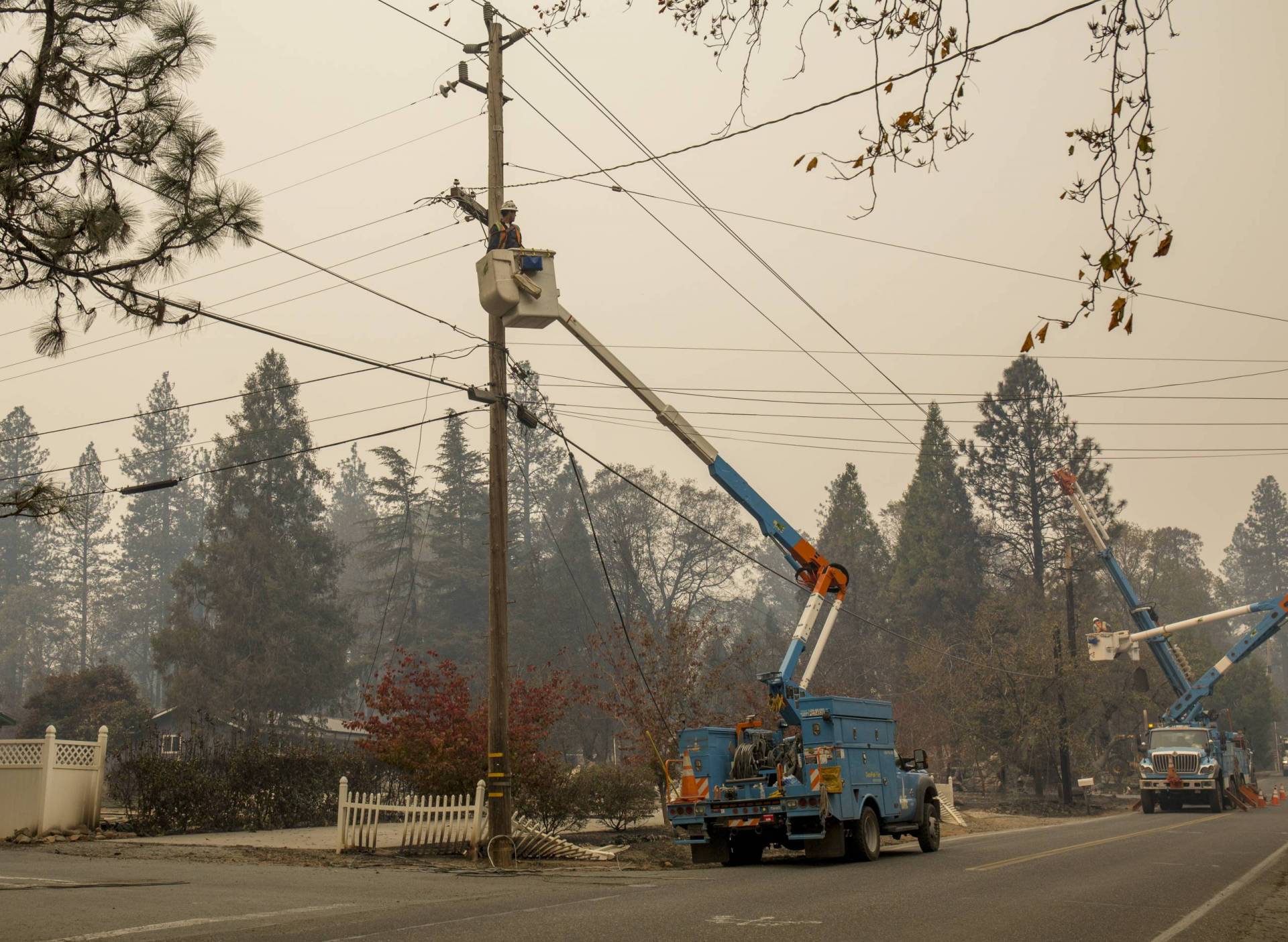PG&E workers cut damaged power lines near Paradise on Nov. 13, 2018, five days after a PG&E transmission line sparked the Camp Fire, the deadliest and most destructive wildfire in modern California history.