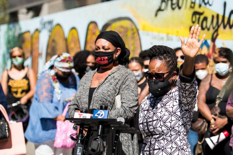 Cat Brooks (L) and Carroll Fife (R) speak at a Sept. 24, 2020, rally in Oakland to protest a Kentucky grand jury's decision not to charge any officers for the death of Breonna Taylor.