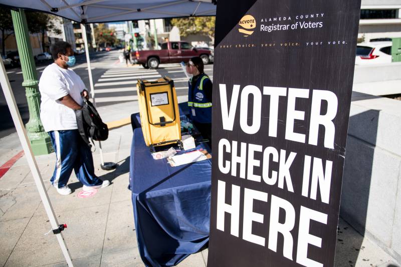 A voter approaches an Alameda County Registrar of Voters ballot drop box in Oakland on Oct. 27, 2020.