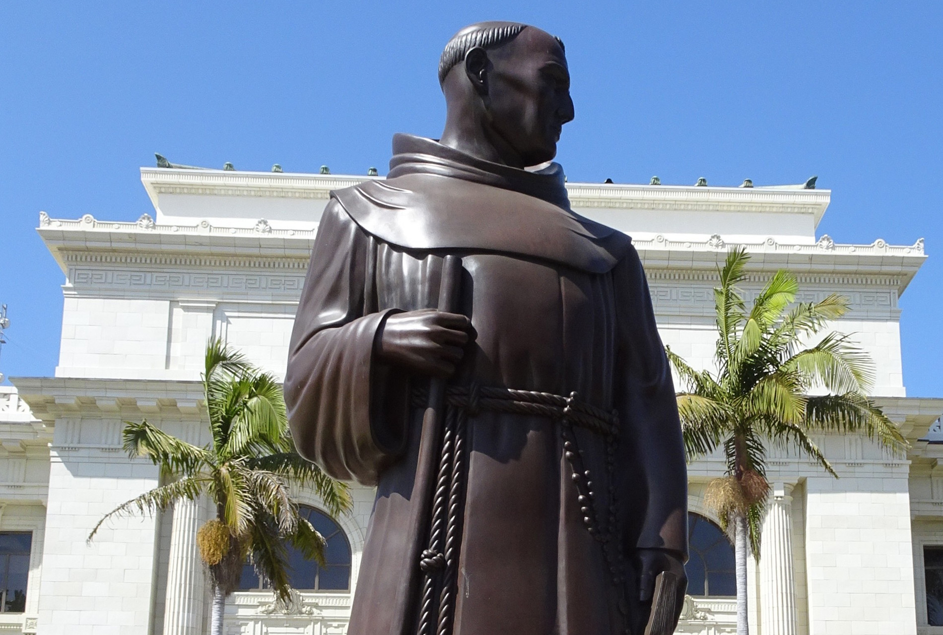 A bronze figure of the 18th century missionary Junípero Serra stands outside Ventura City Hall, sculpted in 1936 by Uno John Palo Kangas. Indigenous activists say a reckoning with Serra's legacy is long overdue.