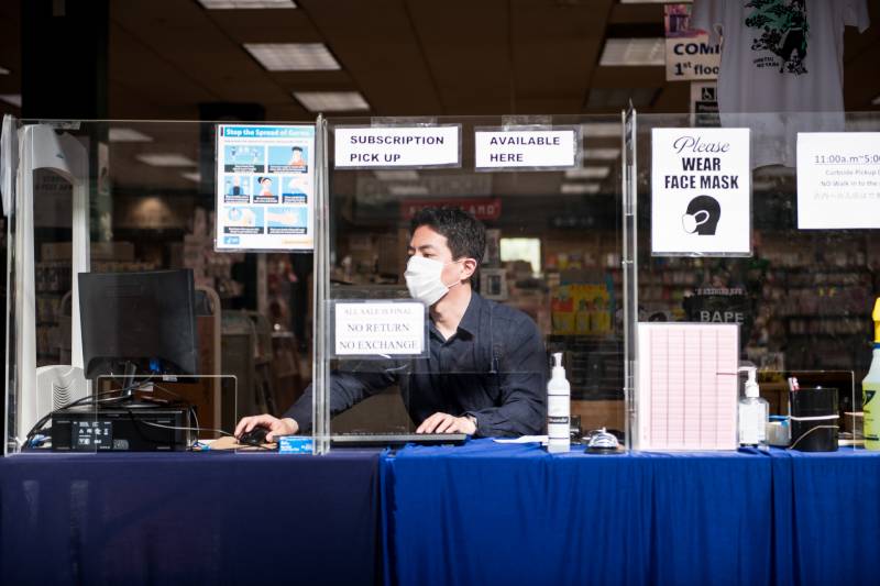 Naoya Morishita, the store manager, works at the Kinokuniya Book Store in the Japan Center West Mall on Sep. 2, 2020.