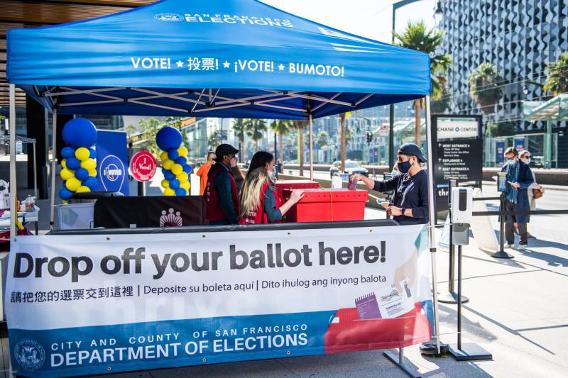 Voters drop off their mail-in ballots at the Chase Center official ballot drop-off location on Oct. 31, 2020.