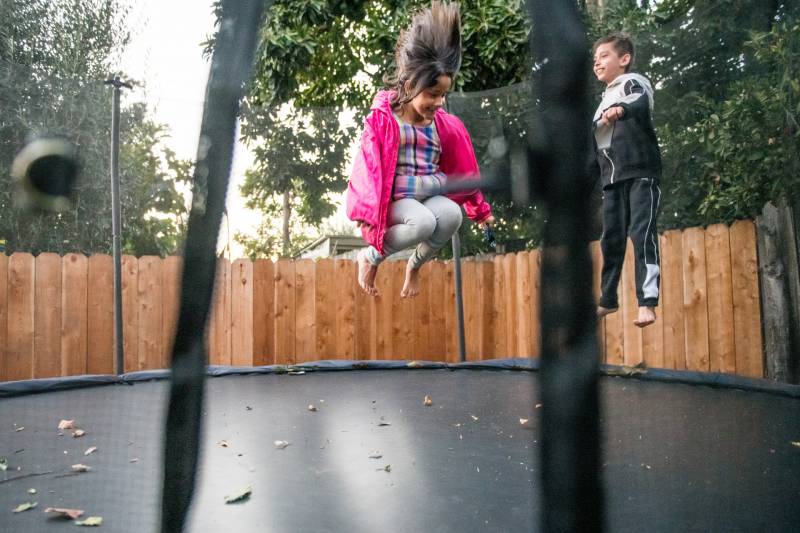 On stressful days Kenley and Anakin Gupta jump on their trampoline at their home in Oakland.