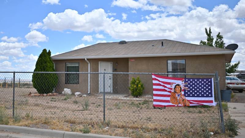An American flag with an image of a Native American printed on it is attached to a fence outside a home in the East To'Hajiilee housing community amid the spread of the coronavirus on May 25, 2020 in To’Hajiilee Indian Reservation, New Mexico.
