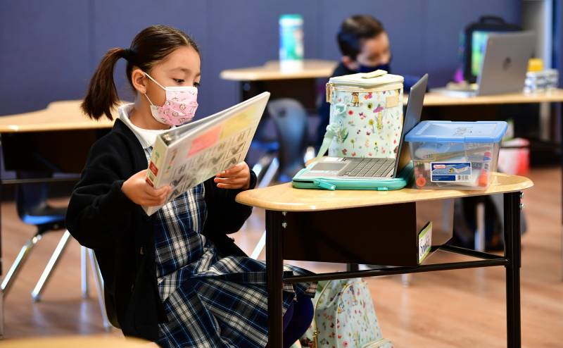 First grade students prepare for class at St. Joseph Catholic School in La Puente, California on November 16, 2020, where pre-kindergarten to second grade students in need of special services returned to the classroom for in-person instruction.