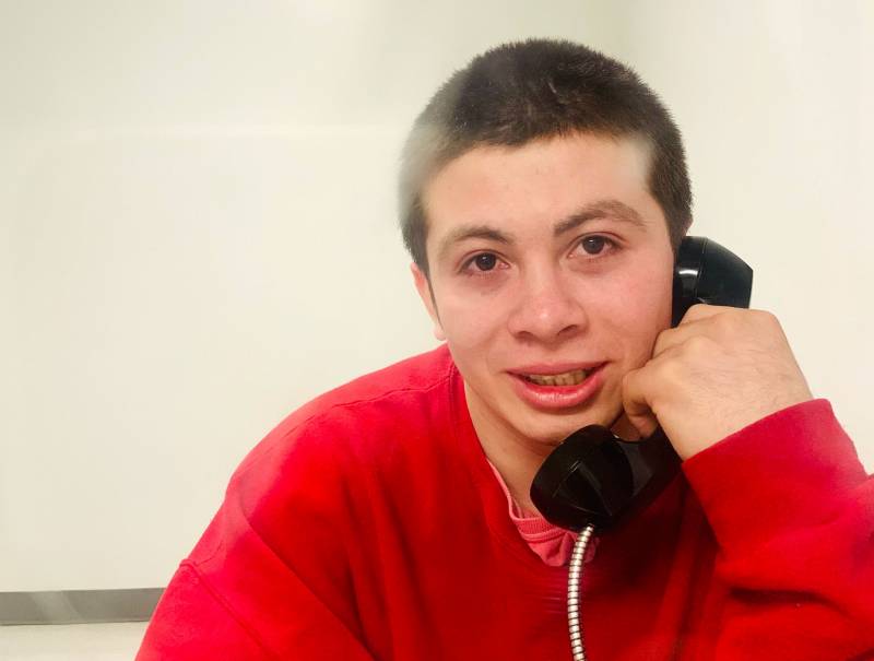 Juan Jose Erazo Herrera speaks to a visitor on a ICE detention center phone