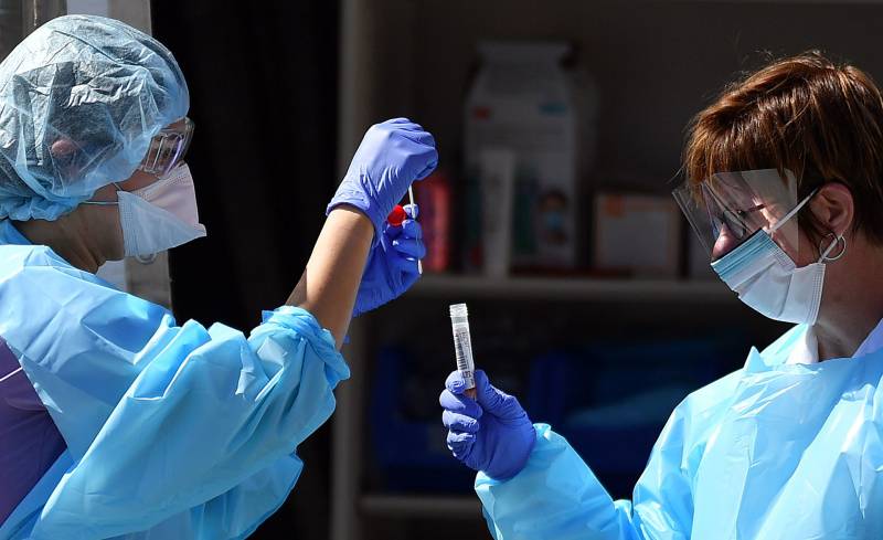 Nurses hold test tubes