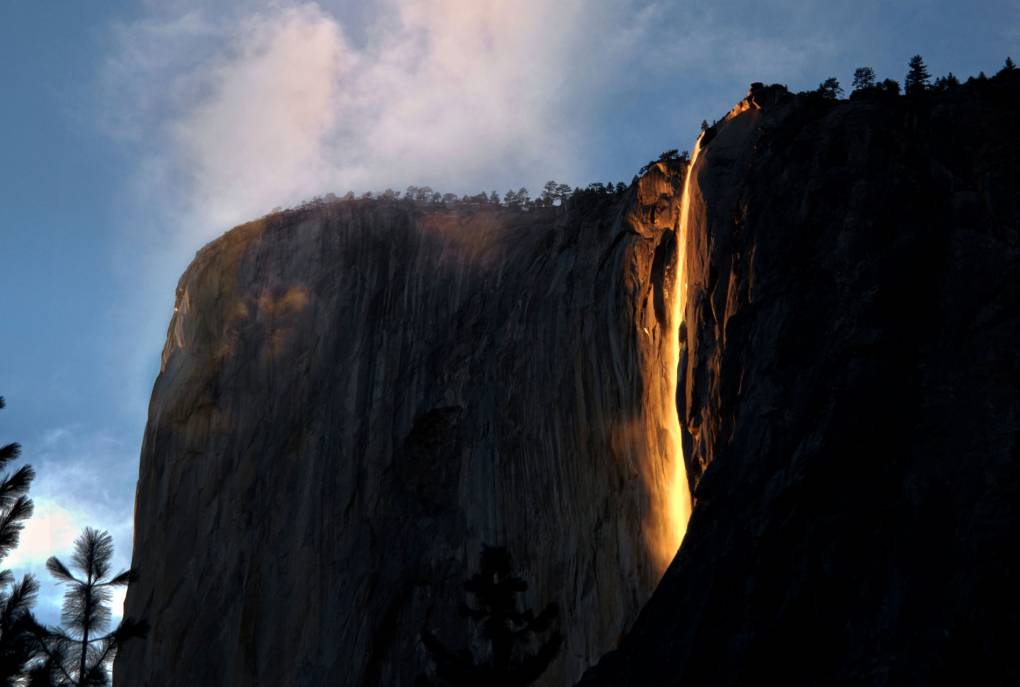 Horsetaill Fall on El Capitan in Yosemite National Park glows with the sunset, looking like flowing lava
